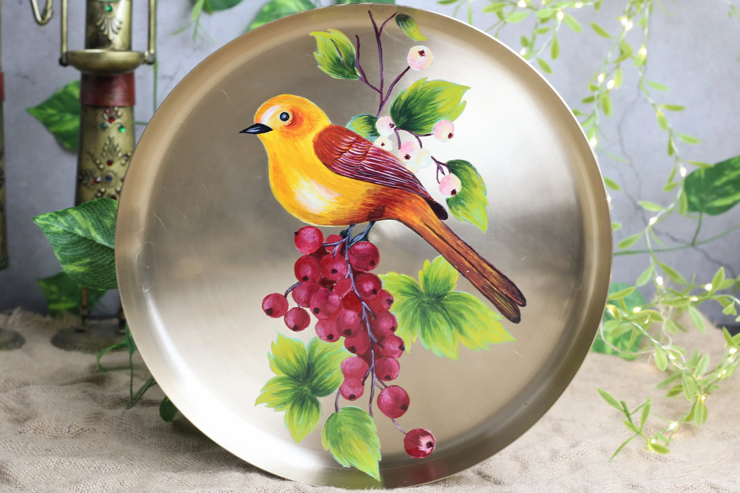 Hand-painted bronze wall hanging featuring birds on red grapes, traditional home decor by Kansyakar.