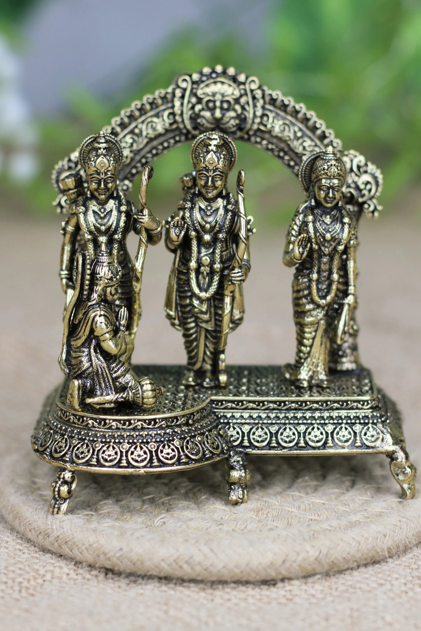 Brass Ram Darbar idol featuring Ram, Sita, Lakshman, and Hanuman in a simple spiritual home decor display.