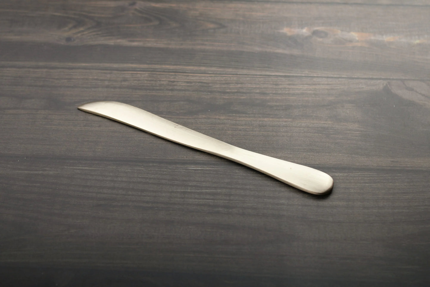 Kansyakar artisan bronze butter knife with a glossy and matte finish, 7.3-inch elegant tableware piece with a sleek design.