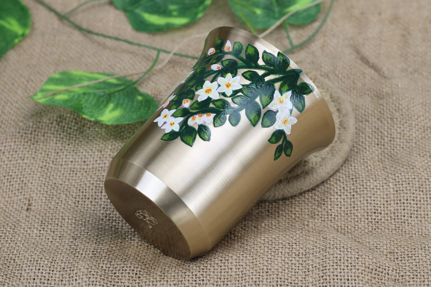 Bronze celebration tumbler by Kansyakar featuring a hand-painted white lily design, 220 ml capacity, ideal as an elegant gift.