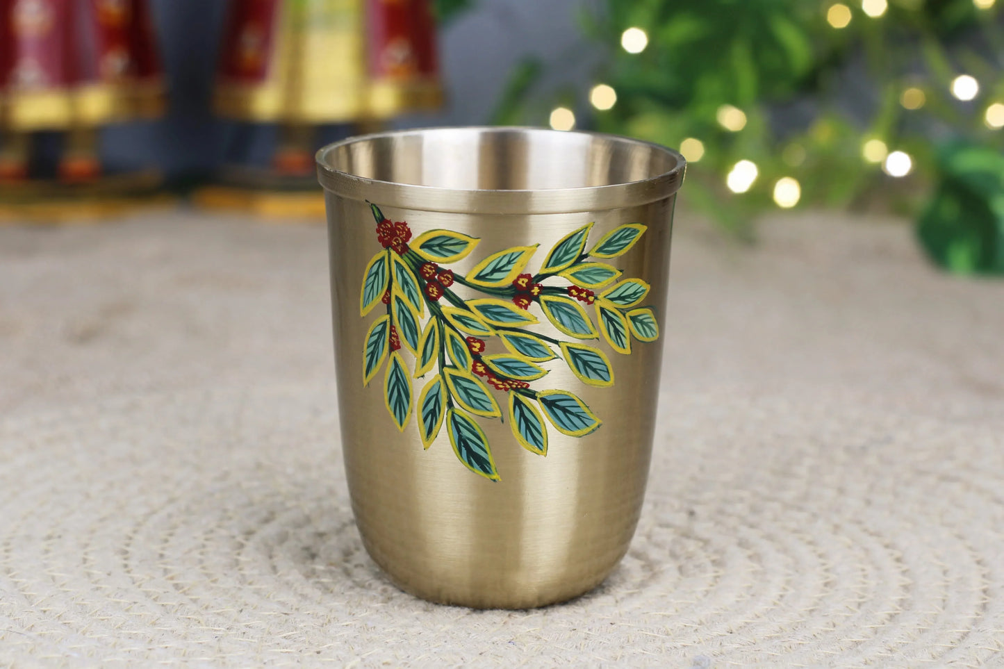 Hand-painted bronze coffee leaf design sipper glass by Kansyakar, matte finish, available in 200ml and 250ml sizes.