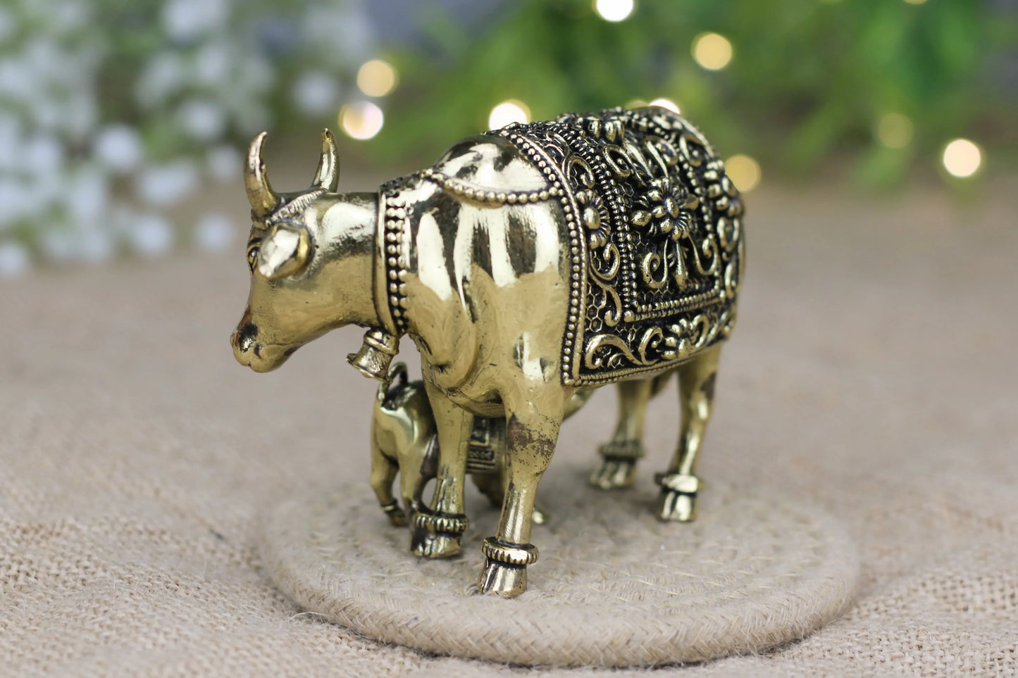 Brass cow and calf idol by Kansyakar, small and medium sizes, symbolizing nurture and prosperity, detailed craftsmanship.