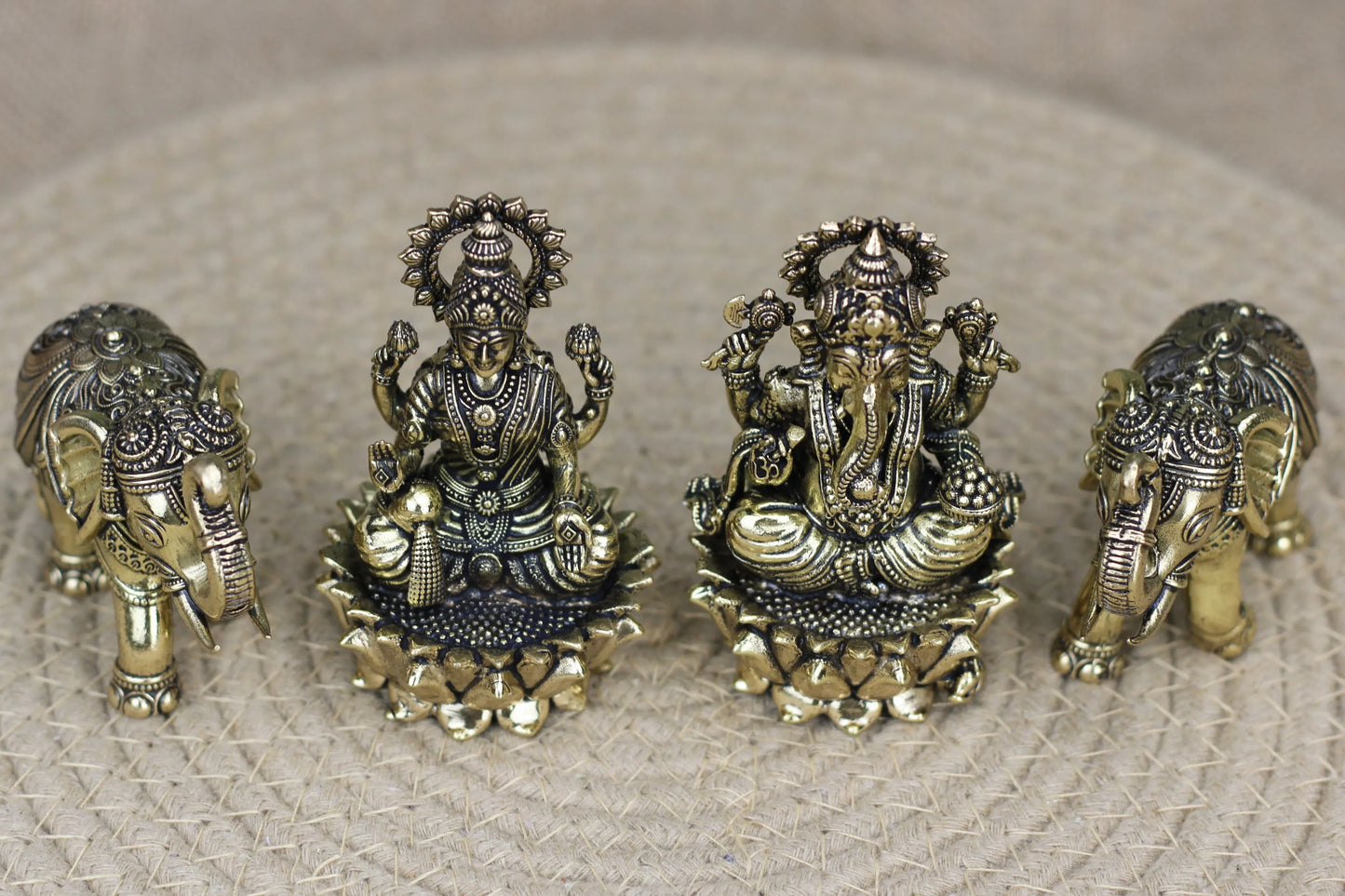 Handcrafted brass Lakshmi and Ganesha idol set with elephants on a lotus, showcasing intricate details and traditional craftsmanship.