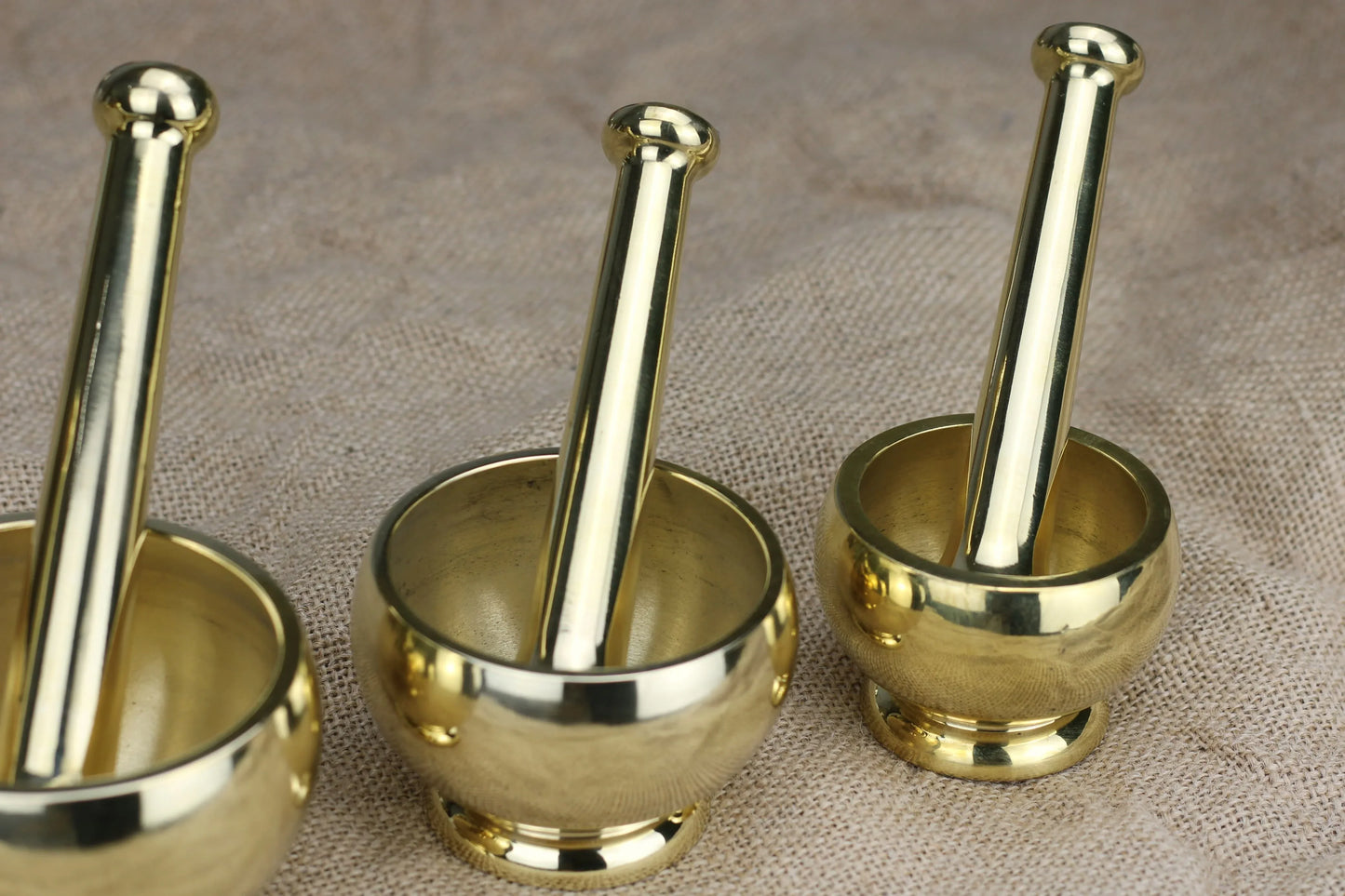 Handcrafted brass mortar and pestle for spices and Ayurveda, featuring traditional Indian design in various sizes.