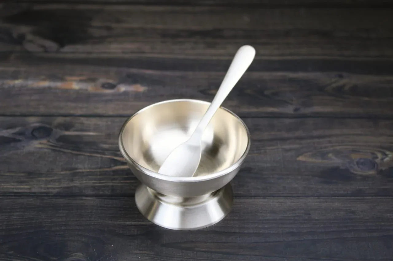 Bronze ice-cream cup with integrated spoon from Kansyakar, featuring a metallic finish for serving frozen desserts.