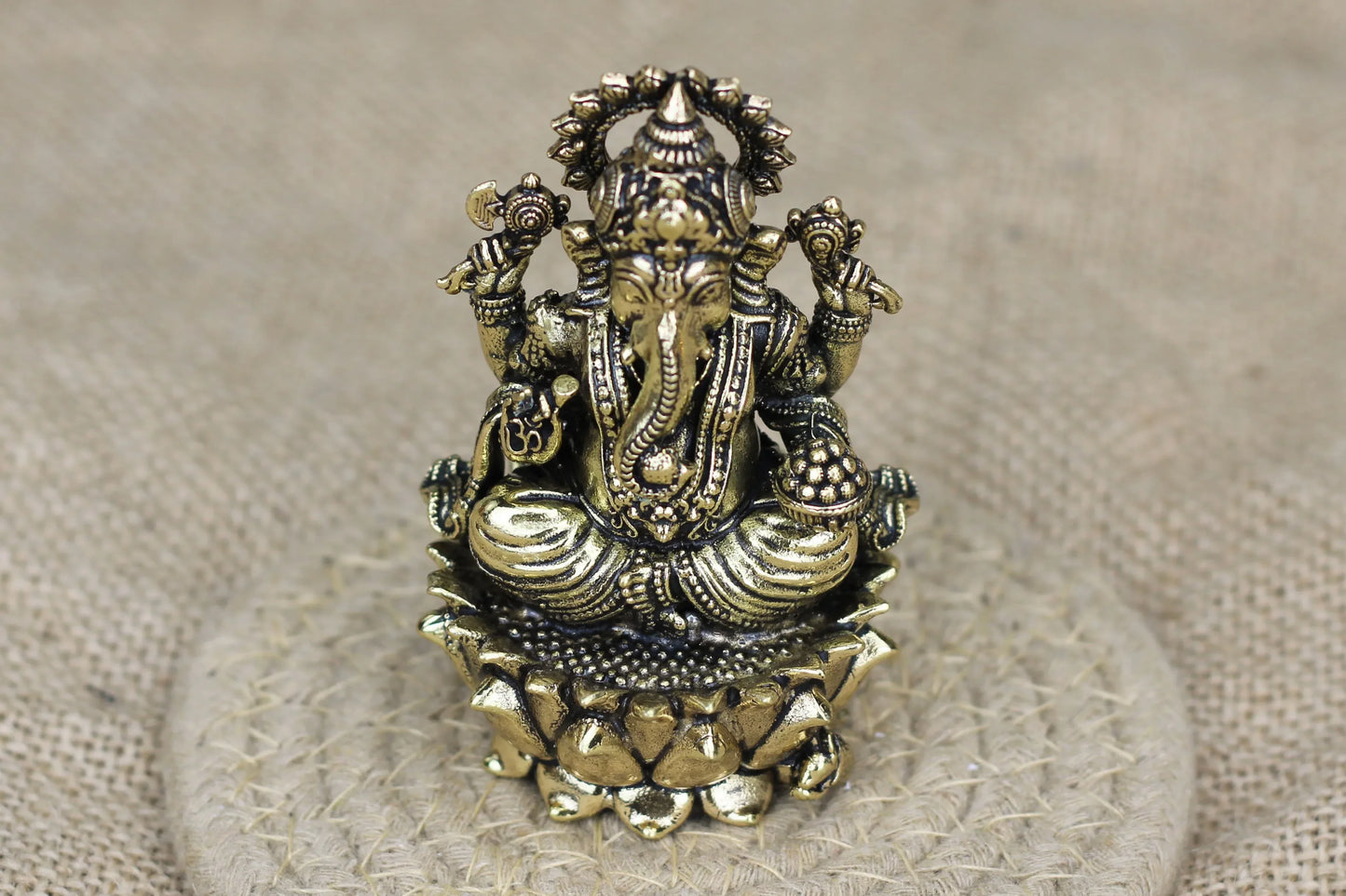 Handcrafted brass Lord Ganesha idol from Kansyakar, available in two sizes, showcasing intricate Indian craftsmanship.