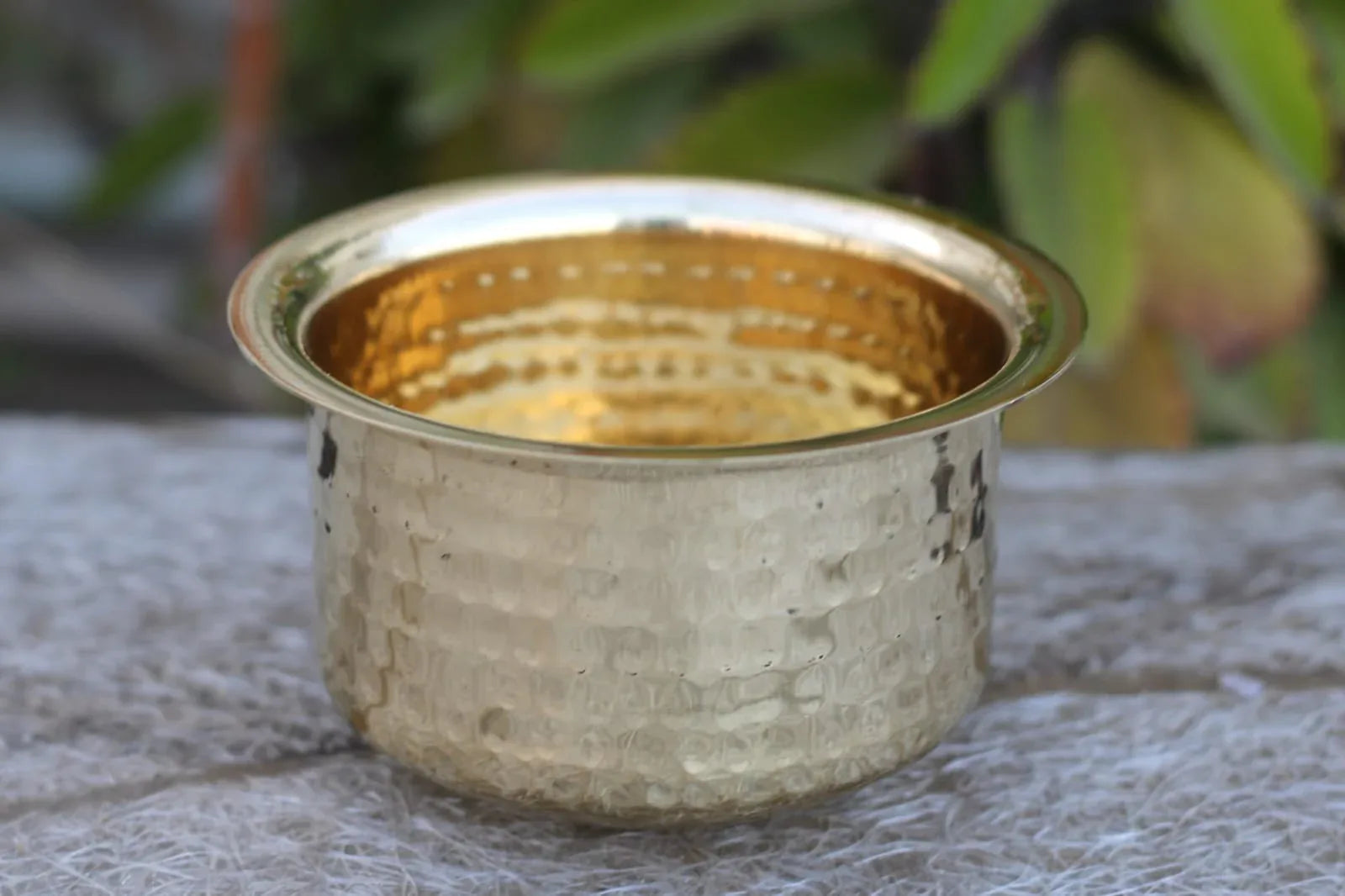 Set of four handcrafted hammered brass Patila cooking pots with glossy finish, traditional Indian brass kitchen cookware by Kansyakar.