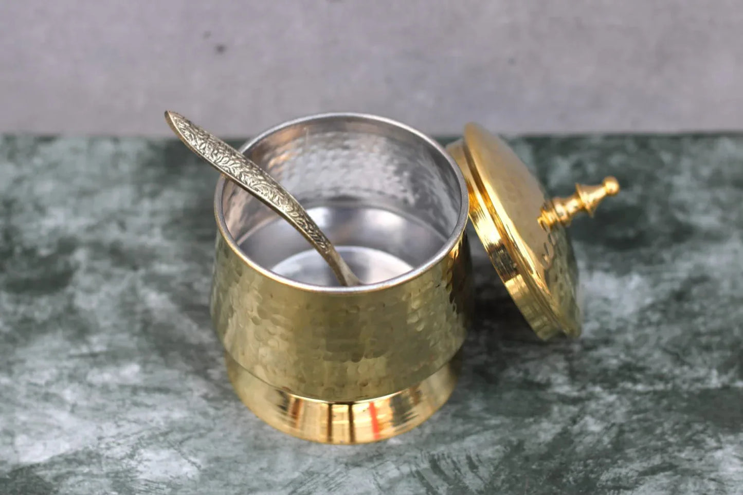 Hammered brass ghee and oil pot with tin coating and designer spoon, 250 ml capacity, handcrafted by Kansyakar.